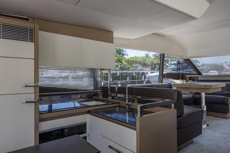 Slide: The Image of Luxurious interior of a 2018 Prestige 520 yacht with modern kitchen and seating area. - 9