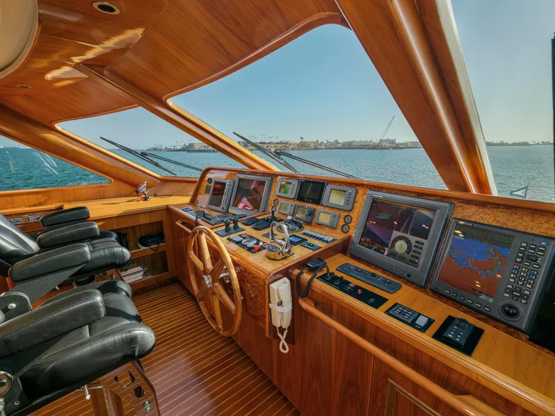 Slide: The Image of Luxurious 2010 President Sterling yacht cockpit with advanced navigation systems and wooden interior. - 21