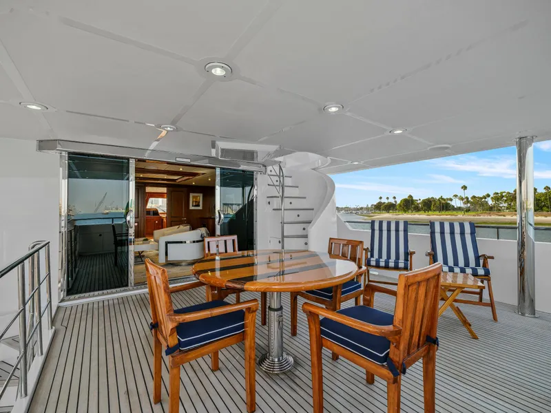 Slide: The Image of Luxury yacht deck with wooden furniture, spiral staircase, and ocean view. President Sterling 2010 model. - 25