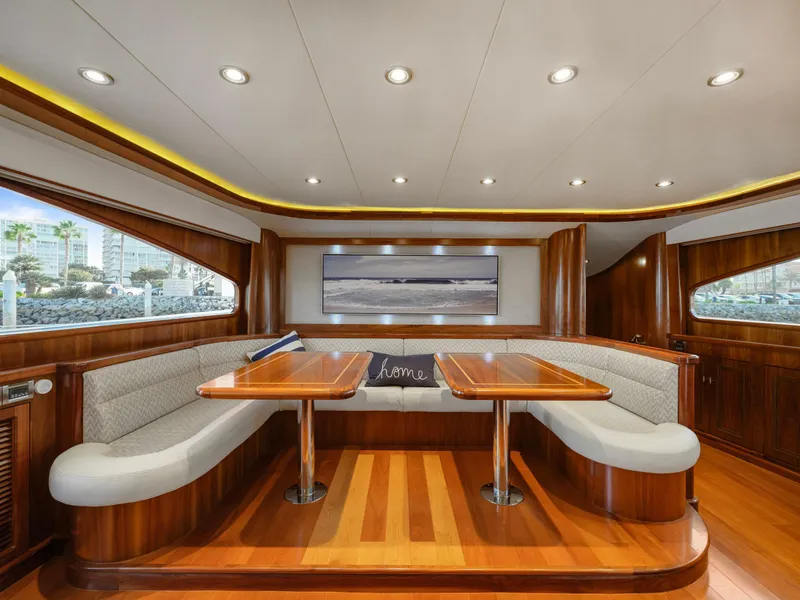 Slide: The Image of Luxurious yacht interior with wooden finish, cushioned seating, and elegant lighting, President Sterling 2010. - 39