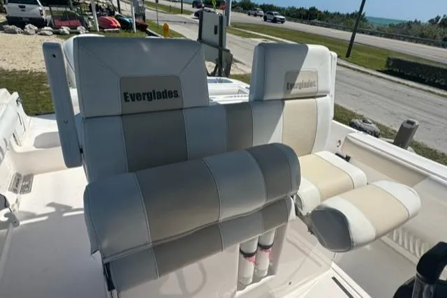 Slide: The Image of 2015 Everglades 295 Center Console boat seats, white and beige upholstery. - 12