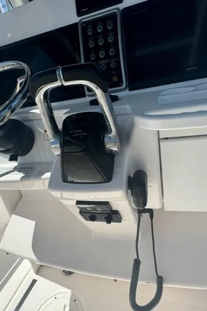 Slide: The Image of 2015 Everglades 295 Center Console boat controls and dashboard. - 16