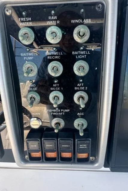 Slide: The Image of Control panel of a 2015 Everglades 295 Center Console boat with various switches. - 18