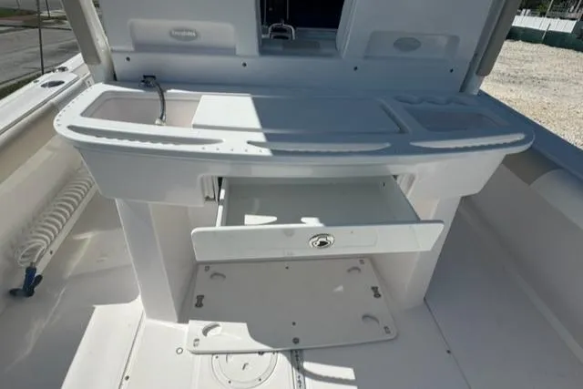 Slide: The Image of 2015 Everglades 295 Center Console boat interior with storage compartments and sink. - 20