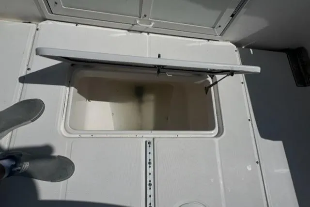 Slide: The Image of Open storage compartment on 2015 Everglades 295 Center Console boat deck. - 21