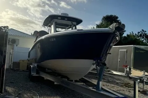 Slide: The Image of 2015 Everglades 295 Center Console boat on trailer, parked outdoors. - 3