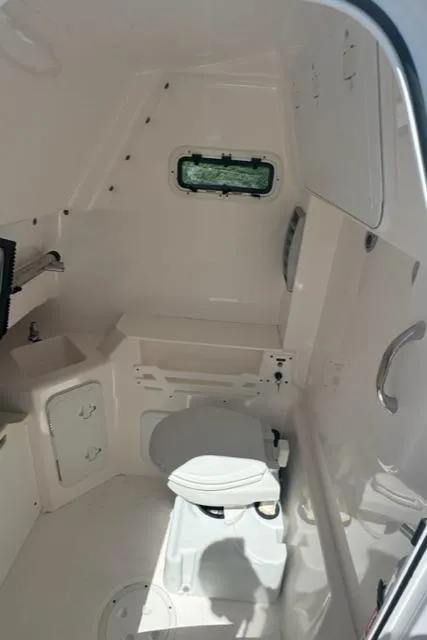 Slide: The Image of Interior of 2015 Everglades 295 Center Console boat with compact marine toilet. - 31