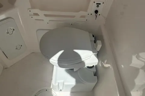 Slide: The Image of 2015 Everglades 295 Center Console boat toilet interior view. - 32
