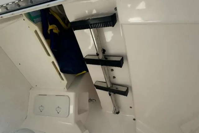 Slide: The Image of Interior view of 2015 Everglades 295 Center Console boat with storage and steps. - 33