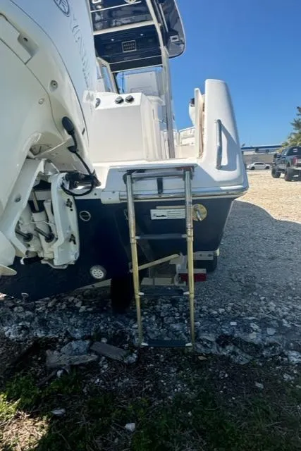 Slide: The Image of 2015 Everglades 295 Center Console boat with ladder, parked on gravel. - 36