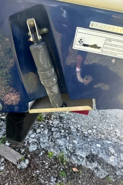 Slide: The Image of Close-up of 2015 Everglades 295 Center Console boat component on rocky ground. - 38