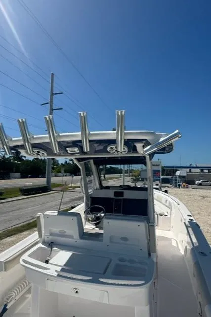 Slide: The Image of 2015 Everglades 295 Center Console boat with T-top under clear blue sky. - 39