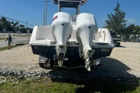 Slide: The Image of 2015 Everglades 295 Center Console boat with dual outboard engines on a gravel lot. - 4