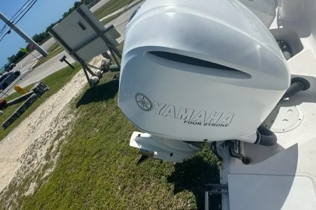 Slide: The Image of Yamaha four-stroke engine on 2015 Everglades 295 Center Console boat, parked outdoors. - 41