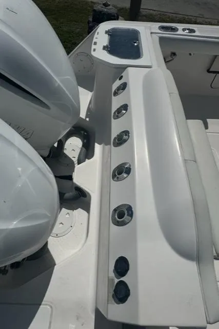 Slide: The Image of 2015 Everglades 295 Center Console boat with dual engines and rod holders. - 42