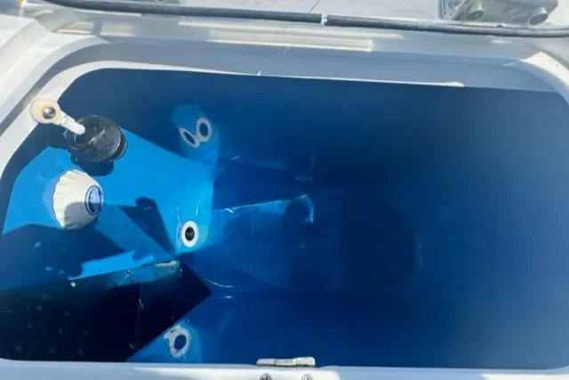 Slide: The Image of Livewell compartment of 2015 Everglades 295 Center Console boat, featuring blue interior. - 43