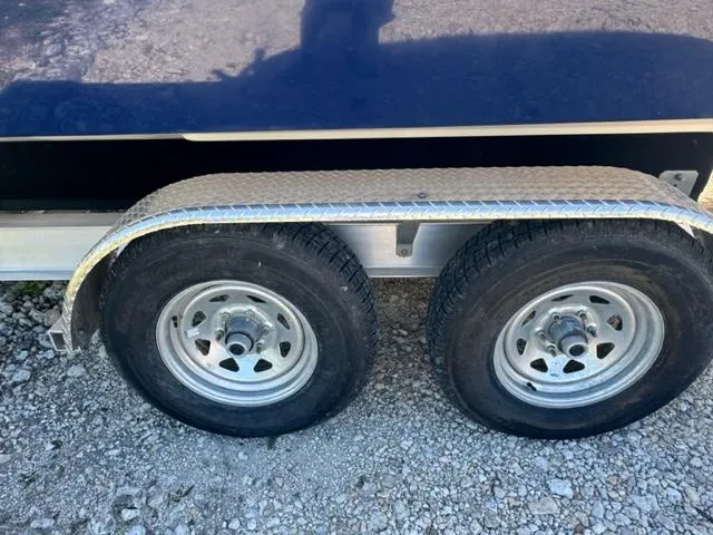 Slide: The Image of Trailer wheels for 2015 Everglades 295 Center Console on gravel surface. - 45