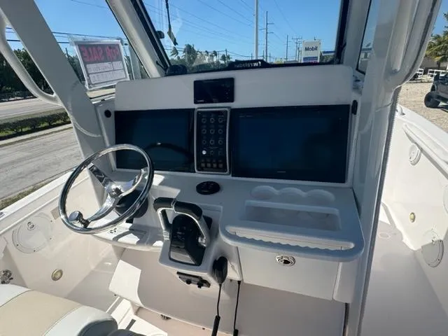 Slide: The Image of 2015 Everglades 295 Center Console boat dashboard with steering wheel and controls. - 7