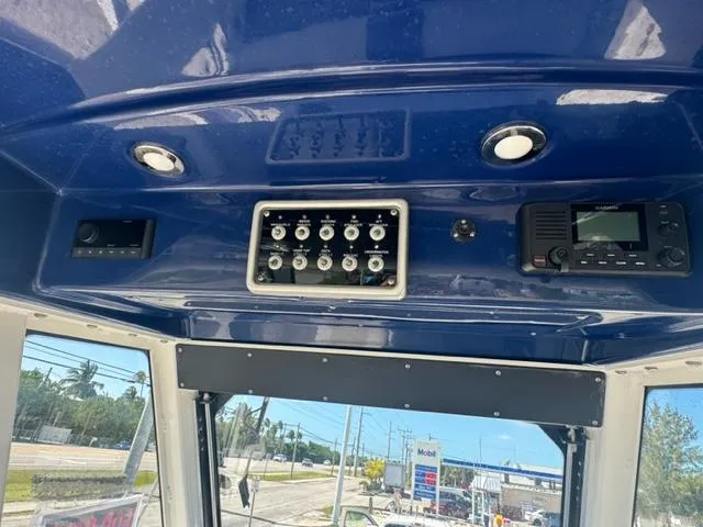 Slide: The Image of Control panel of 2015 Everglades 295 Center Console boat with blue interior. - 8