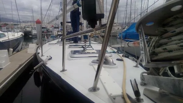 Slide: The Image of 1993 Columbia Cutter sailboat docked in a marina, surrounded by other boats. - 10