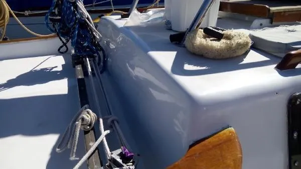 Slide: The Image of 1993 Columbia Cutter sailboat deck with ropes and polished surfaces. - 11