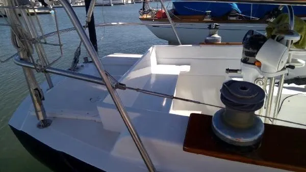 Slide: The Image of 1993 Columbia Cutter sailboat deck with winch and steering wheel in marina. - 13