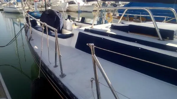 Slide: The Image of Sailboat docked in marina, Columbia Cutter 1993 model, with clean deck and railing. - 17