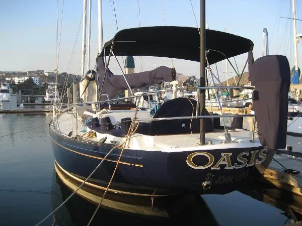Slide: The Image of Sailboat "Oasis" docked, Columbia Cutter 1993 model, in a marina setting. - 23