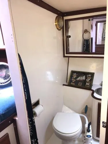 Slide: The Image of 1993 Columbia Cutter boat bathroom with nautical decor and compact design. - 33