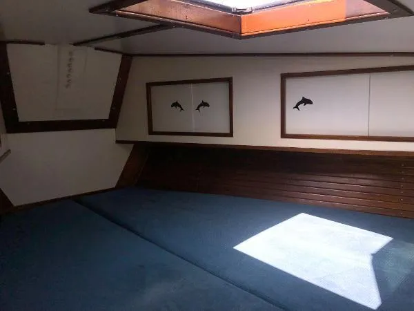 Slide: The Image of Interior of 1993 Columbia Cutter boat with skylight and fish-themed decor. - 35