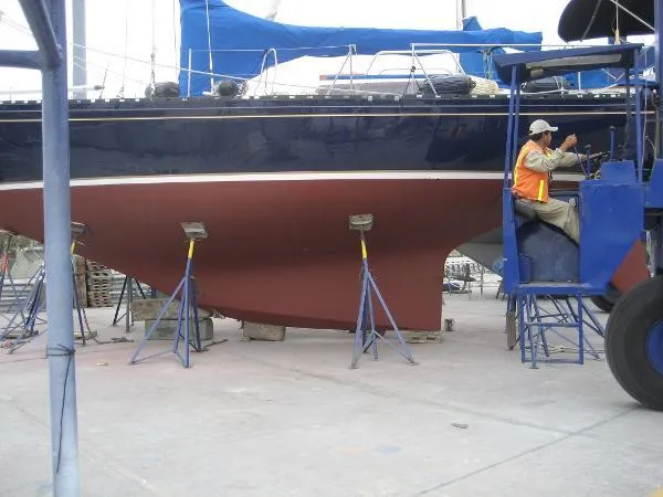 Slide: The Image of A 1993 Columbia Cutter sailboat on stands, undergoing maintenance in a shipyard. - 4