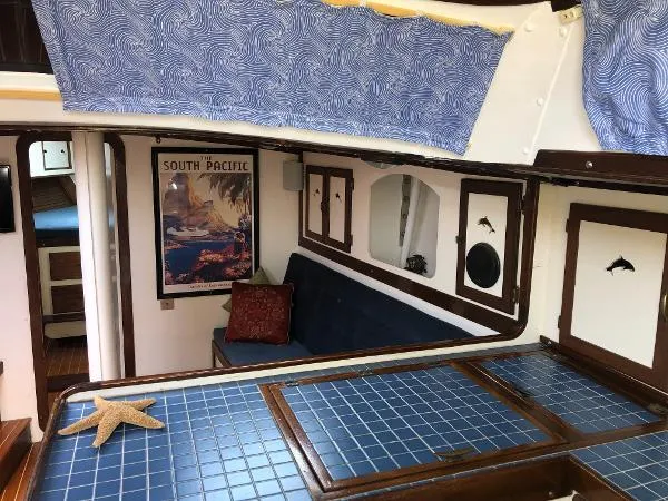 Slide: The Image of Interior of 1993 Columbia Cutter sailboat with nautical decor and blue tile surfaces. - 47