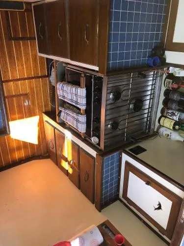 Slide: The Image of 1993 Columbia Cutter kitchen with wooden cabinets, blue tiles, and a compact stove. - 49