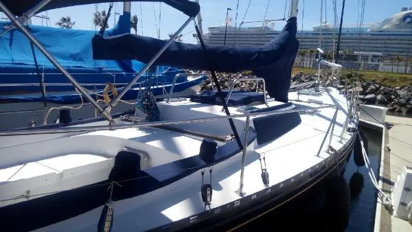 Slide: The Image of Sailboat docked at marina, Columbia Cutter 1993 model, with blue covers and rigging. - 7