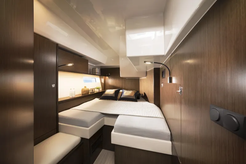 Slide: The Image of Luxurious interior of 2025 Bavaria C57 yacht cabin with modern wood finish and cozy bedding. - 18