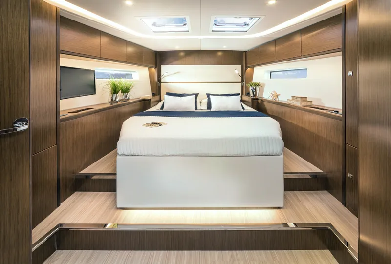 Slide: The Image of Luxurious interior of 2025 Bavaria C57 yacht with modern wood finish and spacious bed. - 21