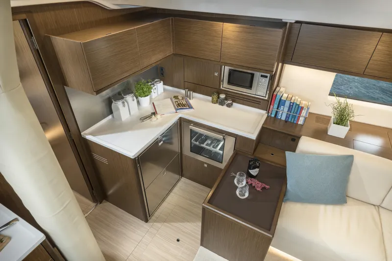 Slide: The Image of Luxurious interior of 2025 Bavaria C57 yacht with modern kitchen and cozy seating area. - 24