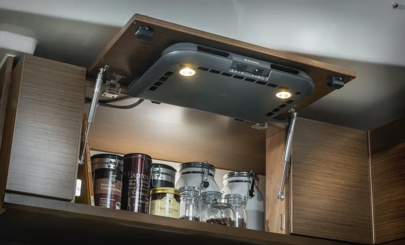 Slide: The Image of Modern kitchen cabinet with Bavaria C57, 2025 model, featuring built-in lighting and storage jars. - 26