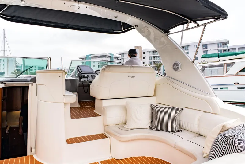 Slide: The Image of 2005 Cruisers Yachts 370 Express with elegant seating and modern helm, docked at marina. - 11