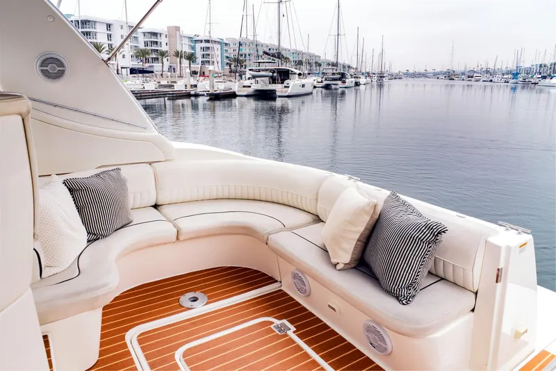Slide: The Image of Luxurious 2005 Cruisers Yachts 370 Express with elegant seating, docked in a serene marina. - 12