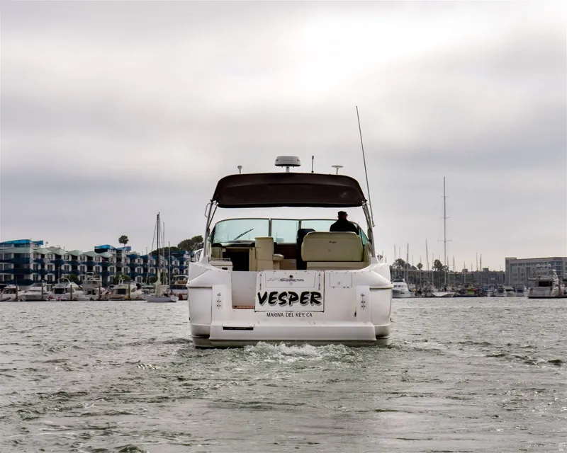 Slide: The Image of 2005 Cruisers Yachts 370 Express on water, rear view, overcast sky. - 2