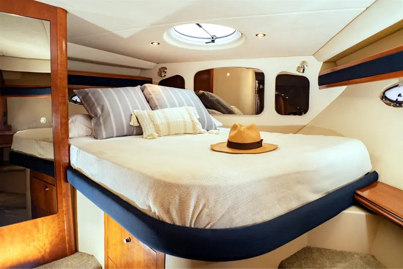 Slide: The Image of Luxurious cabin interior of 2005 Cruisers Yachts 370 Express with cozy bed and stylish decor. - 8