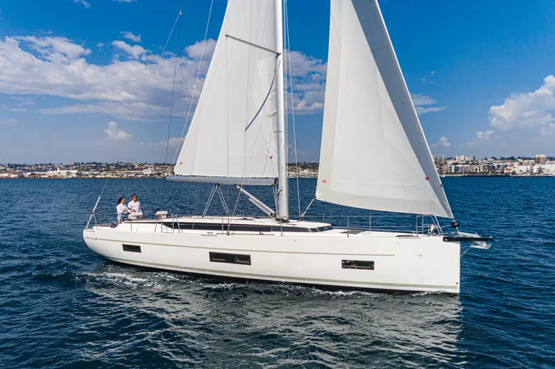 Slide: The Image of 2024 Bavaria C45 sailboat cruising on open water under clear blue skies. - 21
