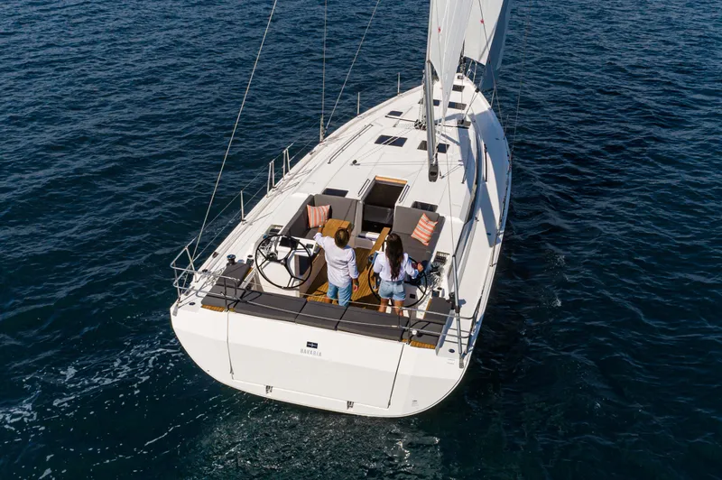 Slide: The Image of 2024 Bavaria C45 yacht sailing on open water, viewed from above. - 23
