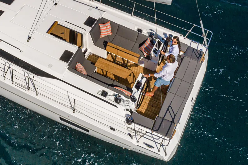 Slide: The Image of 2024 Bavaria C45 yacht with people on deck, sailing on blue ocean waters. - 26