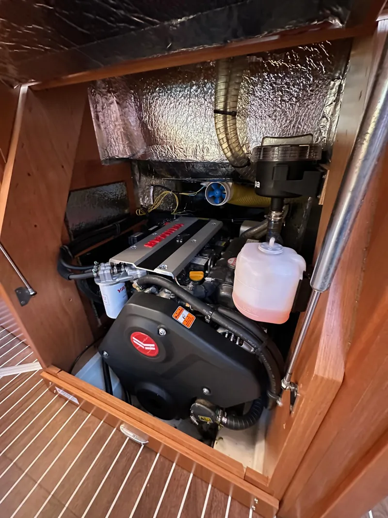 Slide: The Image of 2024 Bavaria C45 engine compartment with visible components and insulation. - 44