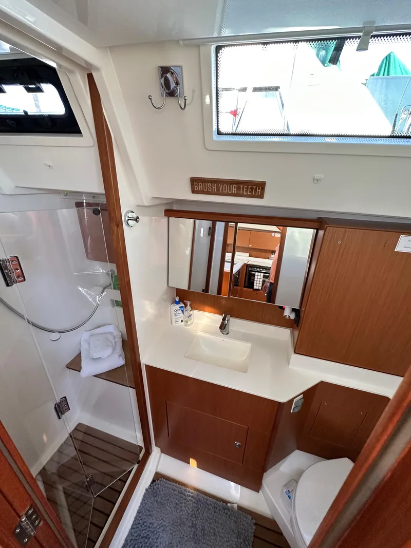 Slide: The Image of 2024 Bavaria C45 yacht bathroom with modern fixtures and wooden accents. - 48