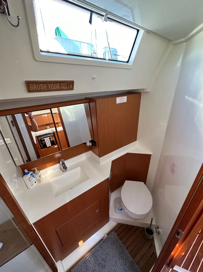 Slide: The Image of 2024 Bavaria C45 yacht bathroom with modern fixtures and wooden cabinetry. - 49