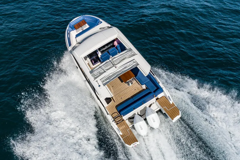 Slide: The Image of 2024 Bavaria Vida 33 yacht cruising on open water, aerial view. - 10