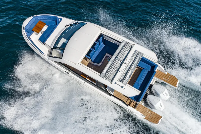 Slide: The Image of 2024 Bavaria Vida 33 yacht cruising on open water, aerial view. - 11